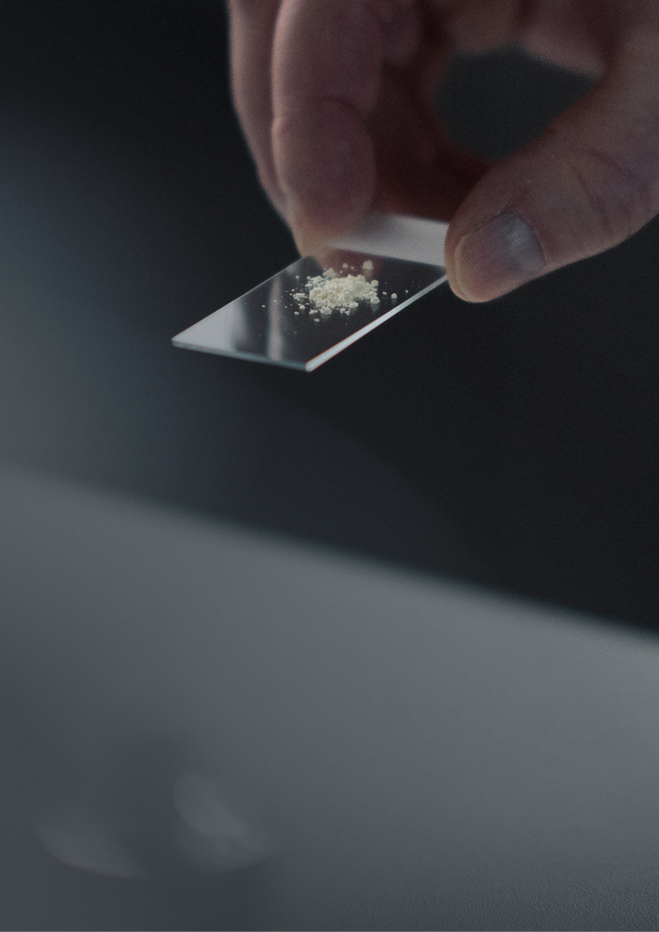 A hand preparing a measured dose of Mitopure